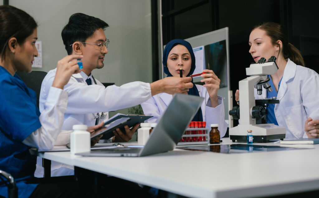 "A diverse team of researchers in a UK laboratory collaborating on scientific experiments, representing opportunities available for Global Talent visa holders."