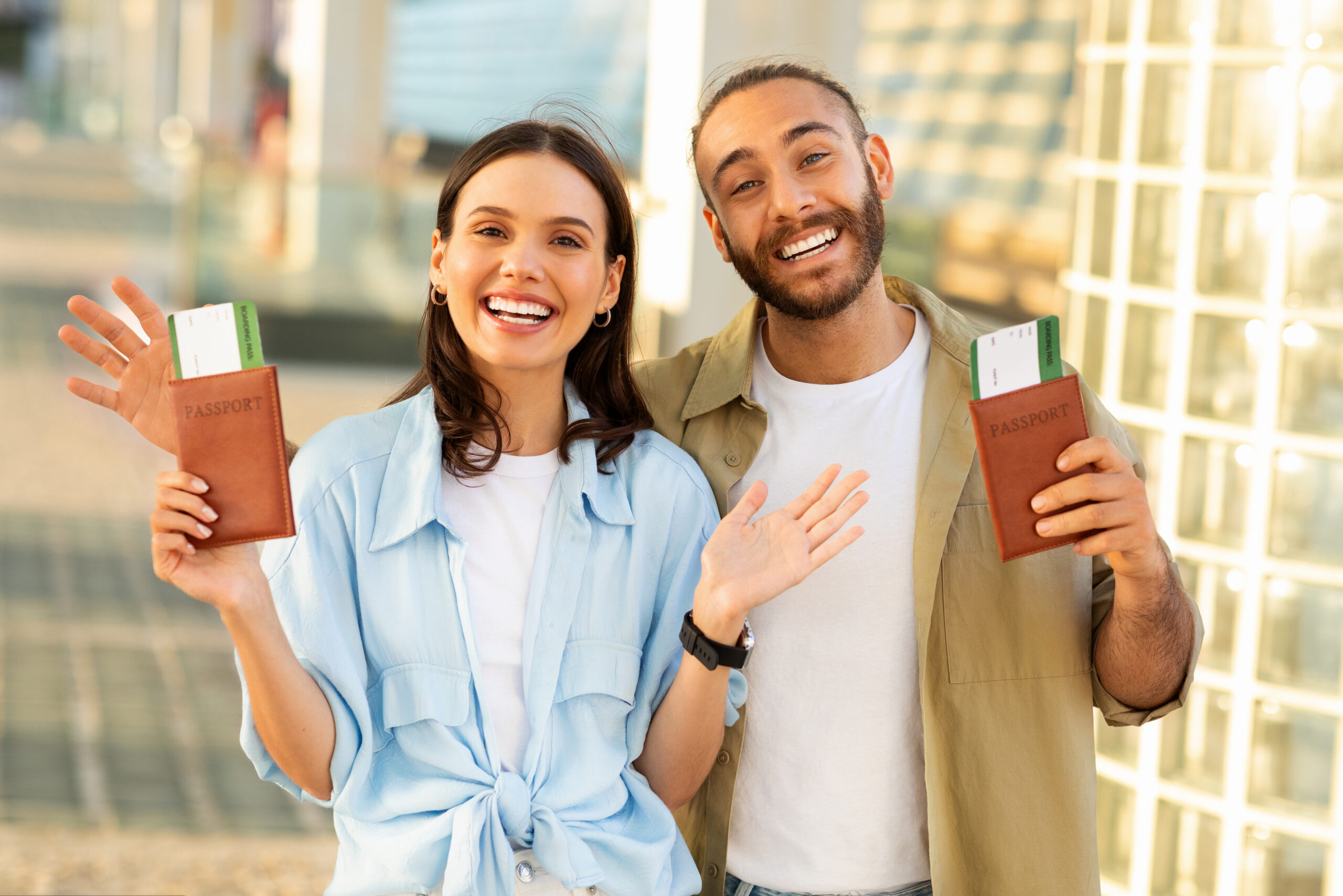 Smiling young professionals holding passports and boarding passes, symbolising opportunities created by the Global Talent Visa in the UK tech industry.