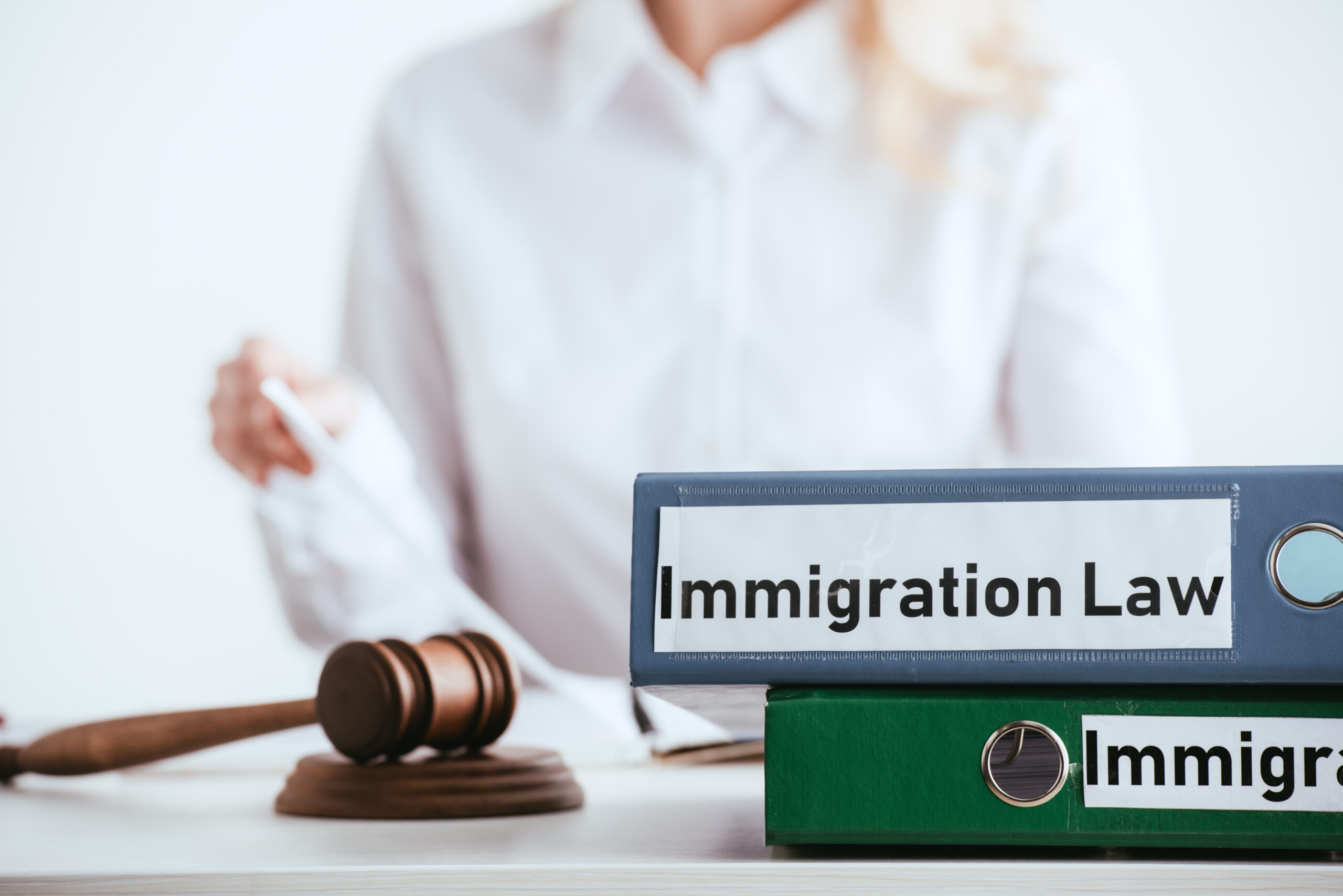 Close-up of immigration law folders and judge’s gavel on a desk, symbolising legal guidance for UK visa applications.