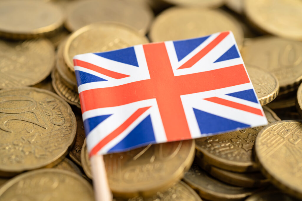 A professional reviewing UK housing, transport, and utility costs on a laptop, representing the financial planning challenges faced by Global Talent visa holders in 2025.
