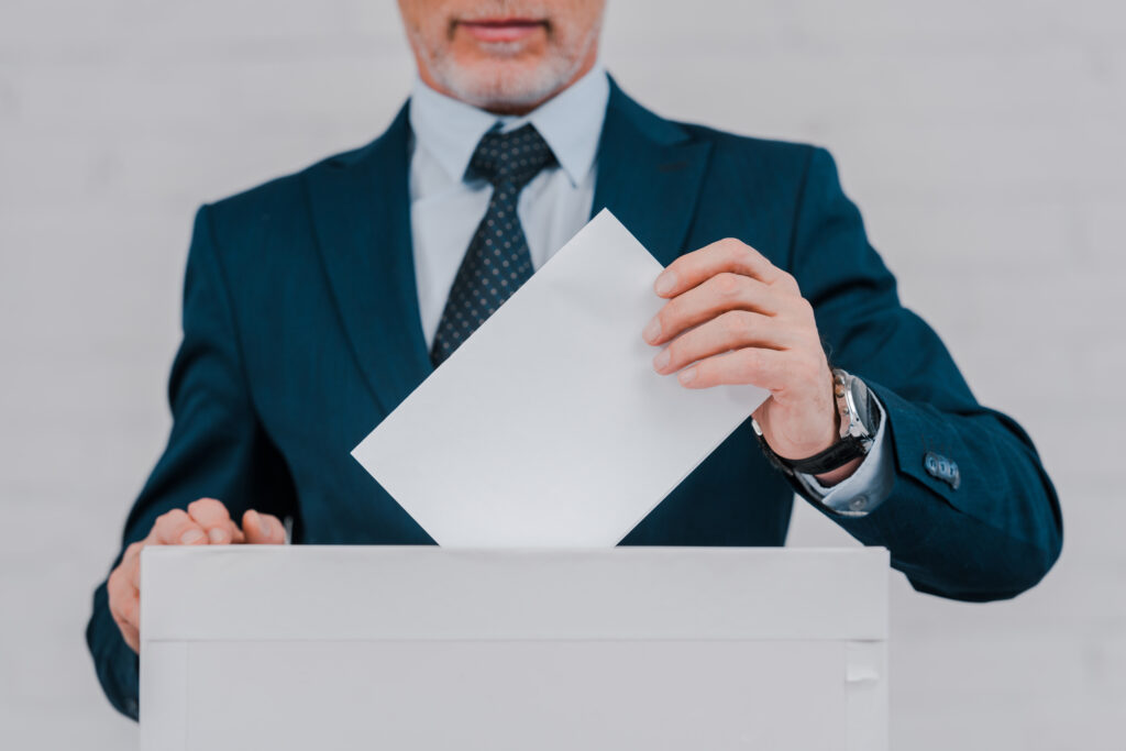 A professional Global Talent visa holder reviewing documents and digital notifications, representing concern over a withdrawn endorsement and planning next steps for career continuity in the UK.