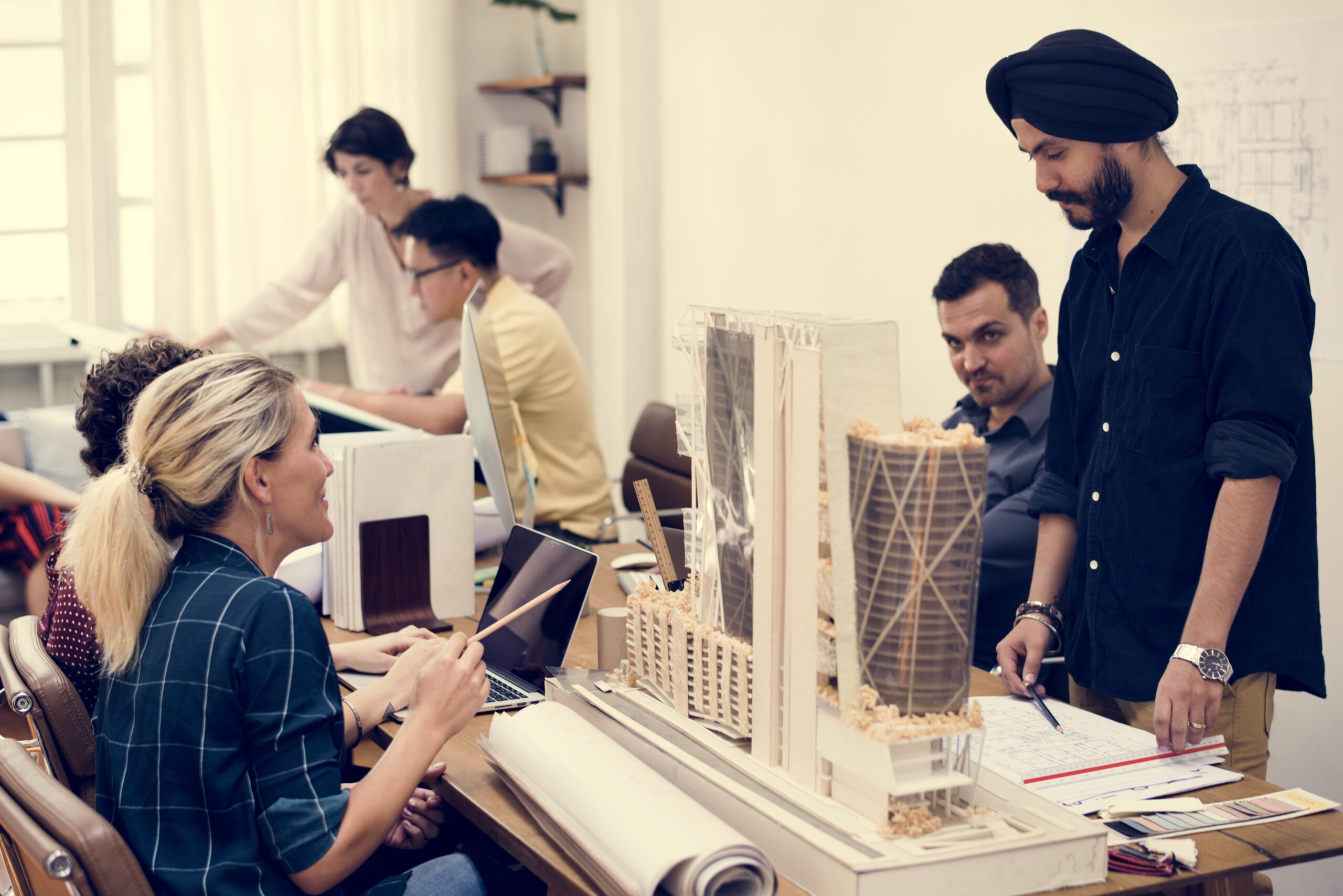 A UK-based architect reviewing design plans in a modern studio, symbolising the Global Talent visa for design and architecture professionals.