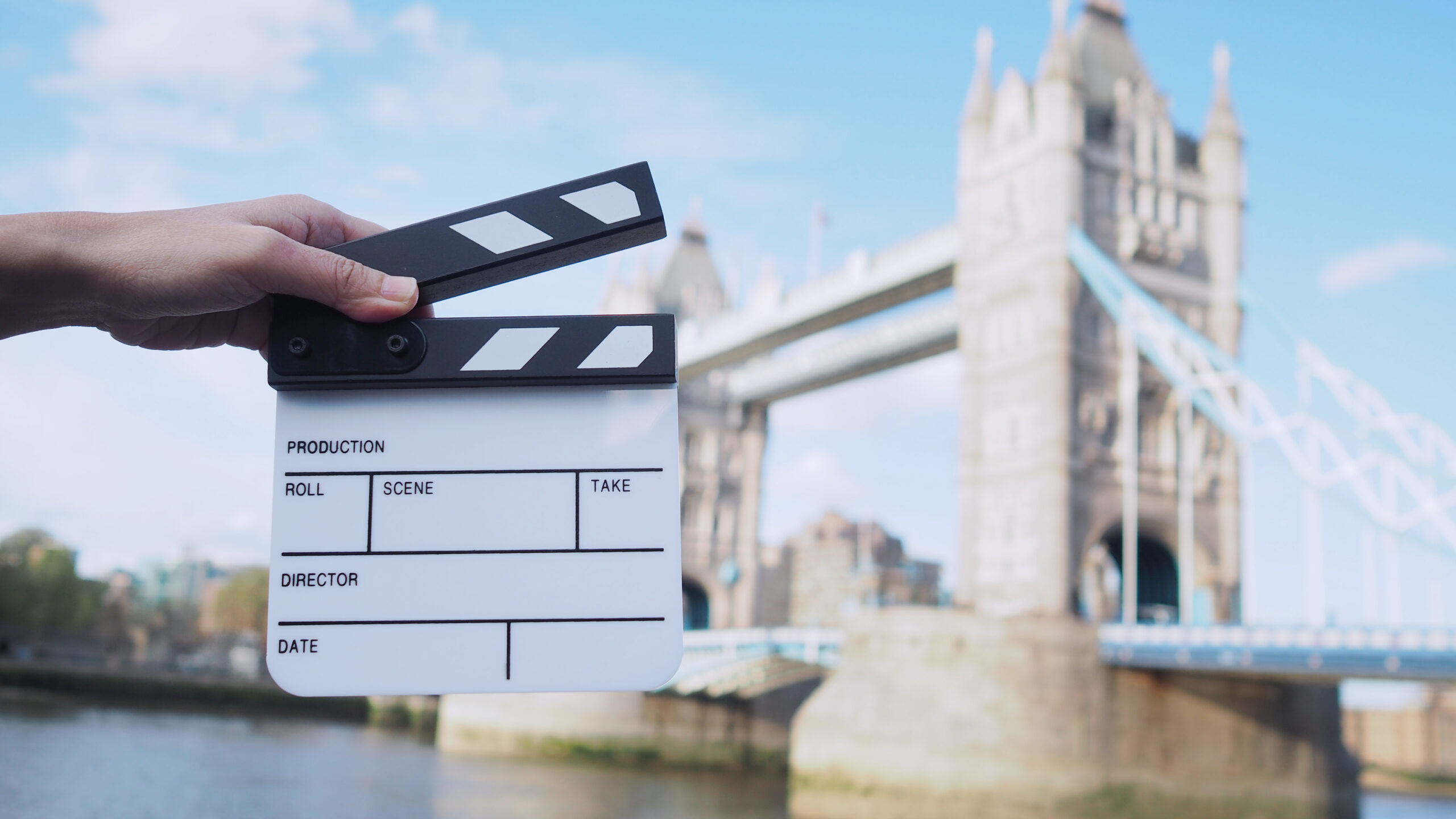 A diverse group of filmmakers, VFX artists, and post-production specialists collaborating on a UK film set, illustrating the creative mobility and international talent supported by the Global Talent visa.